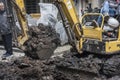 A small excavator in the sewer construction site