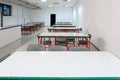 Small factory cafeteria room with empty seats and table