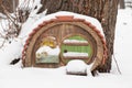 Small fairytale wooden house in a tree in a park in winter Royalty Free Stock Photo