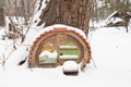 Small fairytale wooden house in a tree in a park in winter Royalty Free Stock Photo