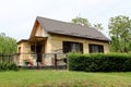 Small family house with dilapidated outdoor surrounded with grass and trees Royalty Free Stock Photo