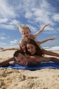 Small family lying on the beach Royalty Free Stock Photo