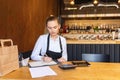 Small family restaurant owner doing finance calculating bills and expenses of small business