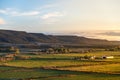 Small farm at sunrise / sunset in mountains