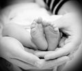 Small feet baby holds his mother in her hands Royalty Free Stock Photo