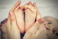 Small feet baby holds his mother in her hands Royalty Free Stock Photo