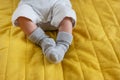 Small feet of a newborn baby in socks. The first month of a baby`s life Royalty Free Stock Photo