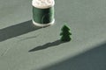 A small felt Christmas tree against a vague background of emerald-colored spools of sewing thread. Royalty Free Stock Photo