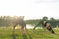 Small female fitness group doing yoga in park on a sunny day Royalty Free Stock Photo