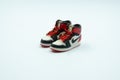 The Small Figure of Air Jordan 1 Black Toe Sneakers Isolated on White Background