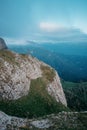 Small figure of person on rocky mountain.