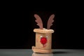 A small figure of a reindeer made of a toilet paper roll by a child