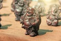 Small figurines of Buddha, Ganesha, Frog in the market of bazaars in India. Souvenir gift India