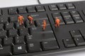 Small figurines of workers repairing computer keyboard Royalty Free Stock Photo