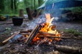 a small fire burning in an improvised campsite