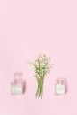 Small first spring flowers lilies of the valley and beautiful glass bottle with dried petals for aromatherapy. Spring or