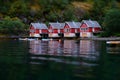 Small fish boat houses at Flam, Norway. Tilt shift effect. Classic red rorbu cabins near the river bank. Fisherman house
