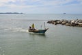 Small fisherman boat sails to the shore