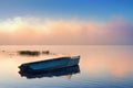 Small Fishing boat anchored near fog on river Royalty Free Stock Photo