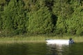 Small fishing boat anchored on the shore of a wild lake in the Canadian forest Royalty Free Stock Photo