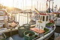 Small fishing boat anchoring in the harbour during a scenic sunset