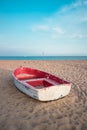 Small fishing boat on the beach and blue sky