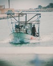 Small fishing boat entering the port in Denia