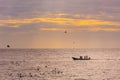 Small fishing boat with fishermen on the sea near Puducherry in South India during sunrise