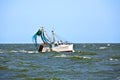 Small fishing boat heading out to the ocean Royalty Free Stock Photo