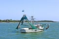 Small fishing boat heading out to the sea Royalty Free Stock Photo