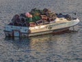 Small fishing boat loaded with crab cages