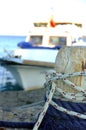 Small fishing boat moored to wooden pole Royalty Free Stock Photo