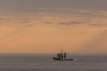 Small fishing boat in the ocean at sunset Royalty Free Stock Photo