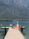 Small fishing boat tied at the wooden dock Royalty Free Stock Photo