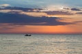 Small fishing boat over seacoast skyline Royalty Free Stock Photo