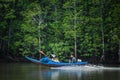 A small fishing boat runs along a mangrove canal called Bor Hin Farmstay in Trang Province Royalty Free Stock Photo