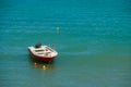 Small fishing boat on the sea in a summer day. Europe. Untouched water colors beauty.boat is standing docked and Royalty Free Stock Photo