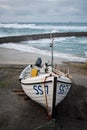 Small fishing boat sheltering from the storm in Sennen Cove Harbour Cornwall UK Royalty Free Stock Photo