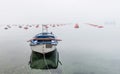 Small fishing boat in the Village at Boka Kotor Bay in the morning fog, Montenegro Royalty Free Stock Photo