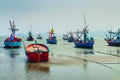 Small fishing boats anchor at beach in cloudy sunset sky Royalty Free Stock Photo