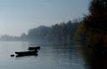 Small fishing boats anchored on the quiet river in morning fog Royalty Free Stock Photo