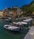 Small fishing boats line up along the quay in front of the old town of Porto Venere, Italy Royalty Free Stock Photo