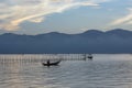 Small fishing boats and lonely man in the bay with magic of the sky and clouds at sunrise part 3 Royalty Free Stock Photo