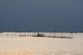 Small fishing boats and lonely man in the bay with magic of the sky and clouds at sunrise part 5 Royalty Free Stock Photo