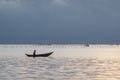 Small fishing boats and lonely man in the bay with magic of the sky and clouds at sunrise part 6 Royalty Free Stock Photo