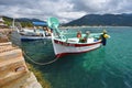 Small fishing boats near the stone pier