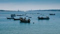 Small fishing boats on the Tagus overlooking the iconic 25 April Bridge, Lisbon, Portugal - Costa Verde Portuguese