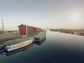 Small fishing port with boats anchored and moored on sea bay in Sweden. Built stony dam, Royalty Free Stock Photo