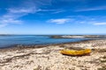 Small fishing rowboat on a beach in coastal town