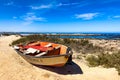 Small fishing rowboat on a beach in coastal town